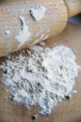 flour on wooden board and rolling pin