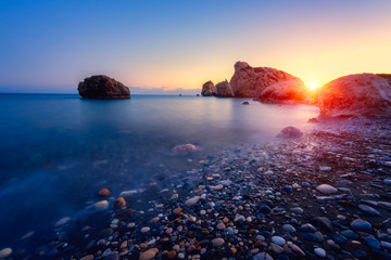 Amazing sunset seascape, famous Love beach on Cyprus with rocks and sea pebbles, travel background....