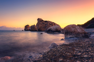 Amazing sunset seascape, famous Love beach on Cyprus with rocks and sea pebbles, travel background....