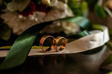 Pair of wedding golden rings on the white tape