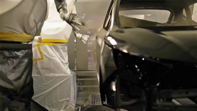 the robot covers the car body with base enamel.
