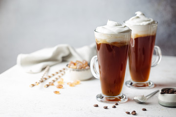 Iced coffee in a tall glasses with cream poured over