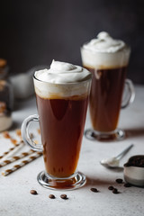 Iced coffee in a tall glasses with cream poured over