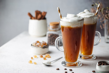 Iced coffee in a tall glasses with cream poured over