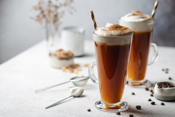 Iced coffee in a tall glasses with cream poured over