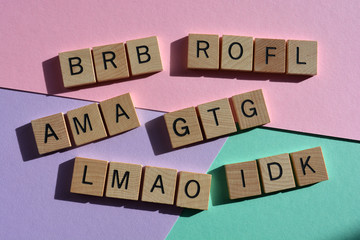 Internet slang, acronyms, including AMA, Ask Me Anything,  IDC, I Don't Know, , and GTG Got to Go, on red and green background