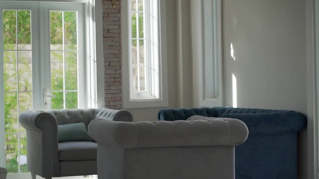 comfortable sofas in the living room with the camera's angle titl reveal the living modern room.