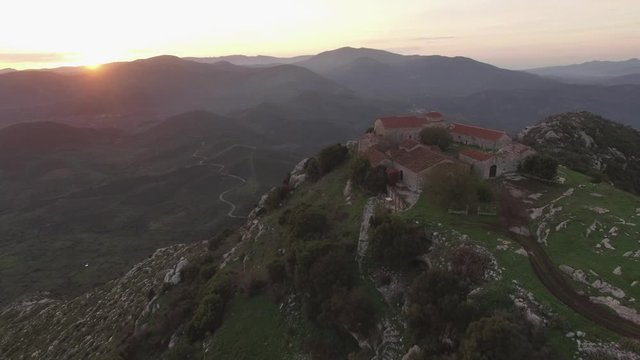 AERIAL: flying over a monastery in the Peloponnese region, greece, while the sun sets