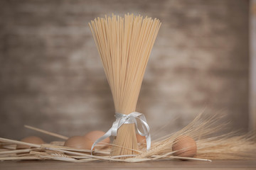 Bundle of spaghetti with wheat and brown eggs