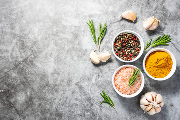 Fresh aromatic spices on dark stone background with copy space for your text. Turmeric, garlic,...