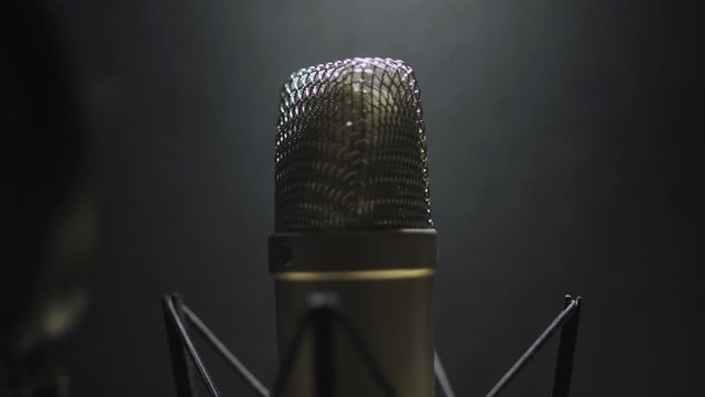 Rack focus to a diaphragm microphone in a recording studio