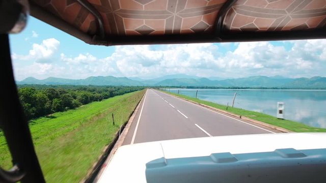 Long and green road into the Udawalawe National Park in Sri Lanka.