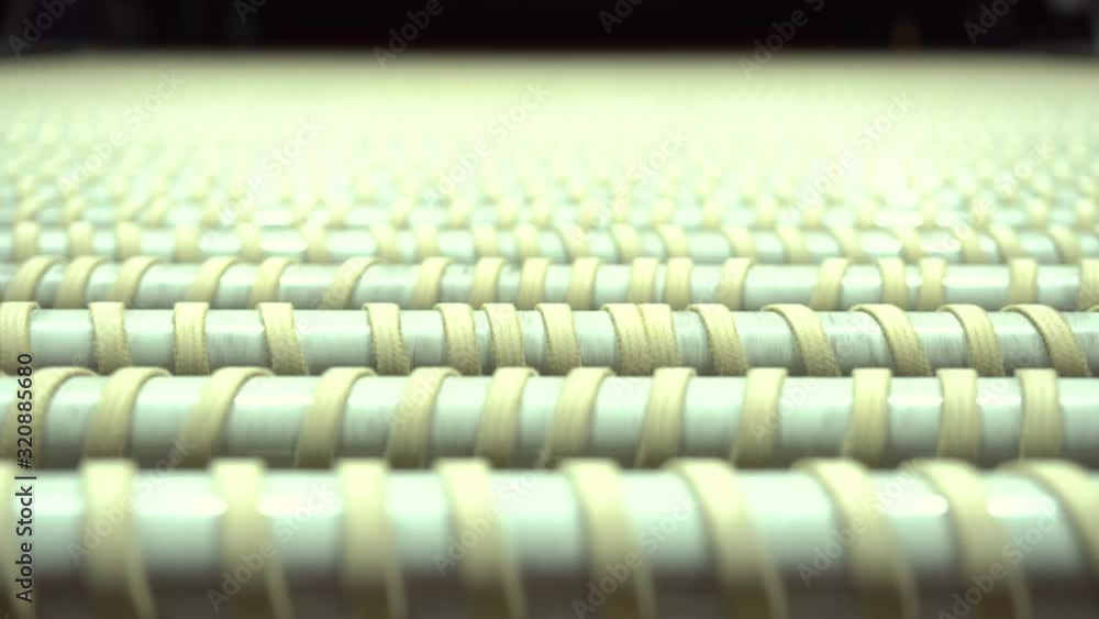 Poster rotating transmission rollers with rubber bands in the factory. transporting products in a factory. 