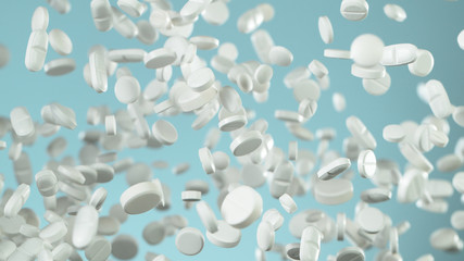 Freeze motion of flying pills on blue background