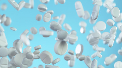 Freeze motion of flying pills on blue background