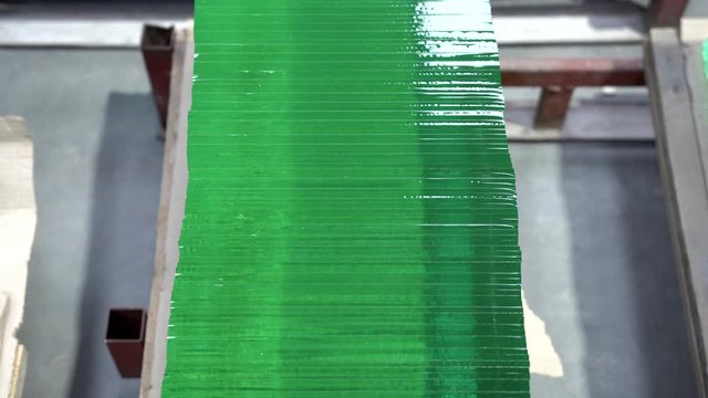 Pile of clear glass elements. Stack of glass sheets cut to size in glass factory.  Sheets of green clear glass. Layers of transparent material. Glass cutting industry.