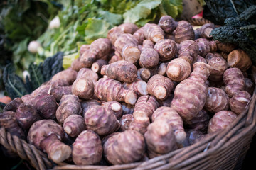 Fresh pink Jerusalem artichoke in box for sale in the market