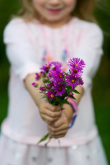 child holding flowers
