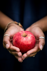 red apple in hand