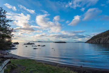 Landscape of water, rocks, and clouds on Rosario Beach on Fidalgo Island in Washington