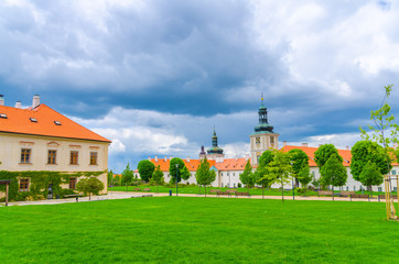 Jesuit College building and green grass lawn of Park GASK in Kutna Hora historical Town Centre,...