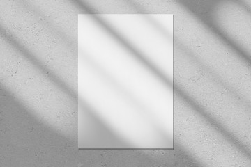 Empty white vertical rectangle poster or business card mockup with diagonal window shadow on the...