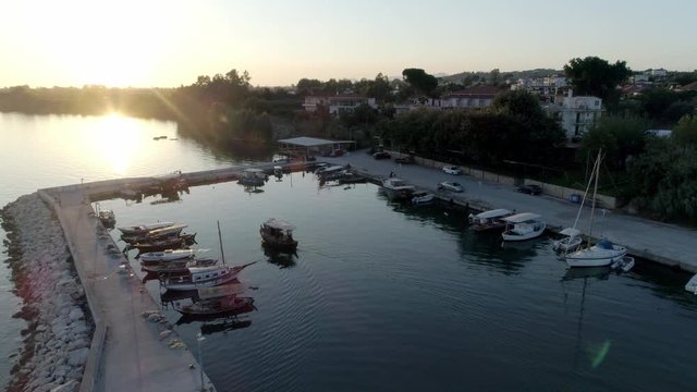 Aerial view of a boat entering the small fishing port a the Ambracian Gulf in Greece, drone footage