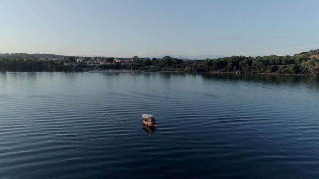 Aerial view of a boat sailing along the deep blue waters of the Ambracian Gulf in Greece, drone footage