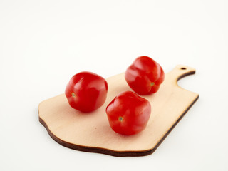 Ripe, red cherry tomatoes of the confetto variety.Isolate.White background
