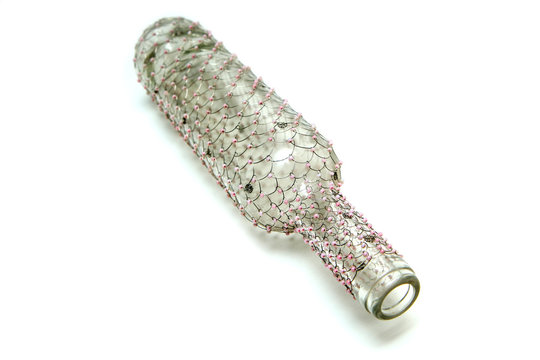 The wire brushed wine bottle.  The traditional decorative craft. In a white background. 