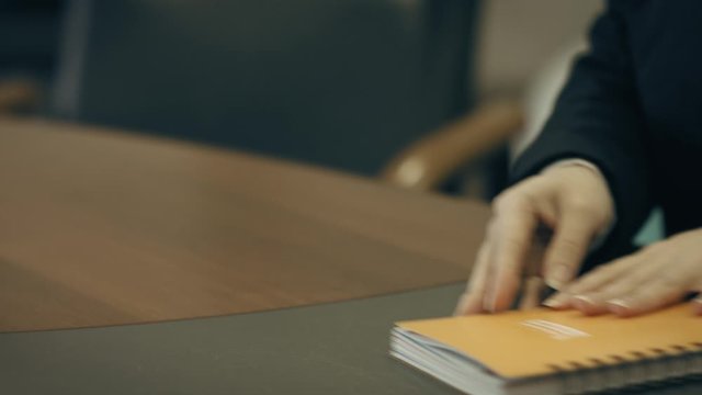 Girl writes in a notebook with a ballpoint pen