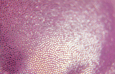 pink synthetic pattern with shiny accents. A fragment of fabric.