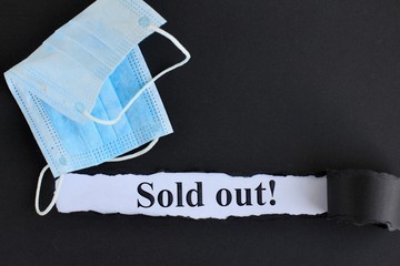 Announcement with Text Sold out! on black background with respiratory protective medical masks