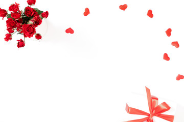 Elegant composition for Valentine's Day. Bouquet flowers of red roses, gift box, hearts on white background. Valentine day, 8th march, Mother day background. Flat lay, top view, copy space