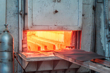 Metal hardening furnace. The door is open, ready to load metal parts.