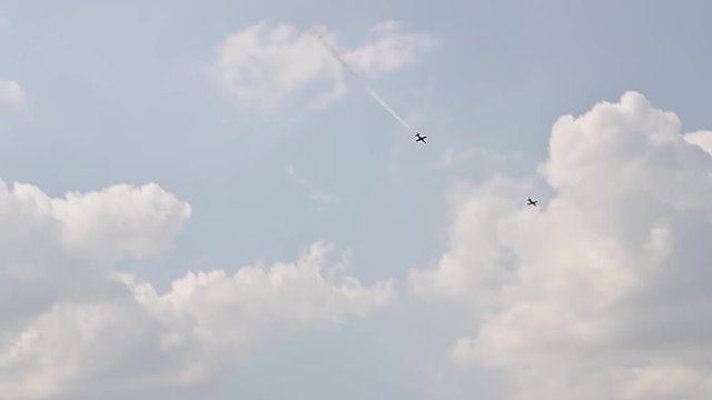3 fighter jets in the blue sky. A general plan. Aerobatic figures. Airshow. 8 seconds