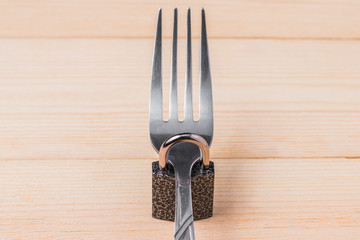 The fork is closed on the padlock. Concept of diet and weight loss.