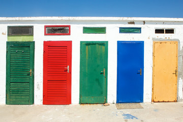 The colorful doors of one of the old changing rooms or cabins at a beach in Croatia. 