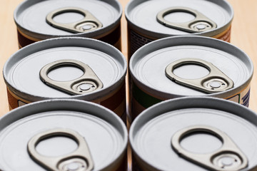 Stack of tin cans with a key. Condensation has formed on the cans.