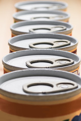 Stack of tin cans with a key. Condensation has formed on the cans. Selective focus