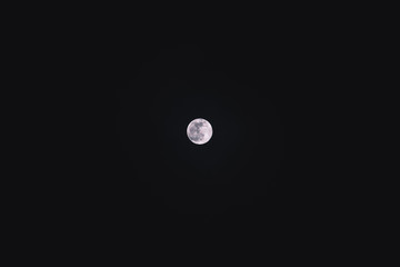 The full moon in the black night sky with a lot of negative space (Jan 10, 2020)