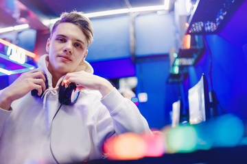 Professional gamer playing tournaments online video games computer with headphones, red and blue - obrazy, fototapety, plakaty