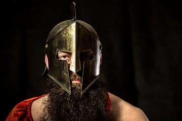 Portrait of Spartan warrior sitting and looking at the camera