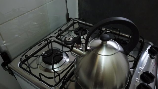 kettle on the stove boiling water to prepare coffee.