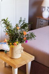 Beautiful of a bouquet of wildflowers and roses in a bed room. Selective focus