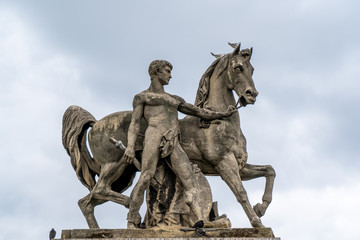 Fototapeta na wymiar Naked man and horse sculpture in Paris France near Eiffel Tower