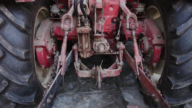 Agricultural tractor axis rear wheel casing, panning closeup