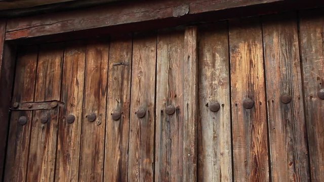 Rustic wooden barn doors and frame. low angle pan right 