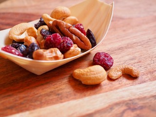 Mixed nuts and dried fruit in a wooden bowl 