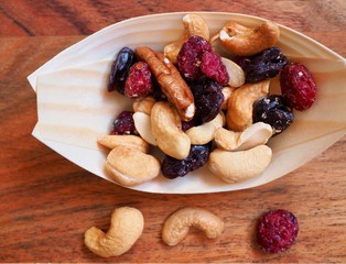mixed nuts and dried fruit in a wooden bowl 